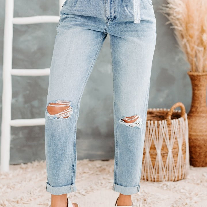 Light wash distressed hole denim trousers with high waist, paperbag style and white belt