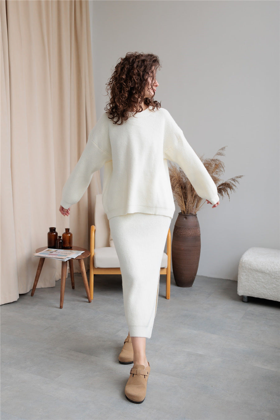 Woman in a white knit sweater and skirt from the Elegant Design Cardigan Knitted Skirt Sets