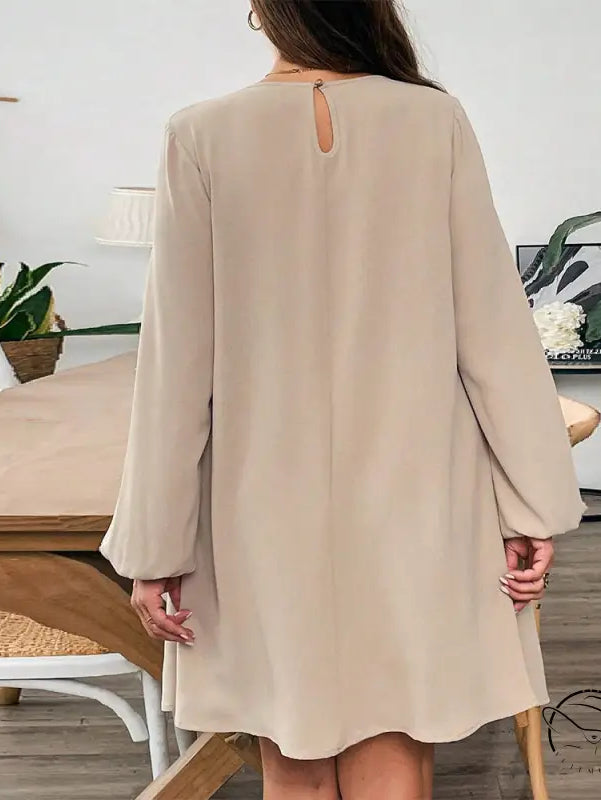 Woman in comfortable beige midi dress with keyhole back neck