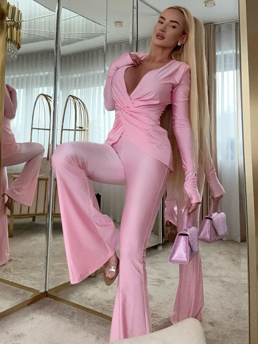 Pink satin long sleeve jumpsuit with ruffled details and high slit