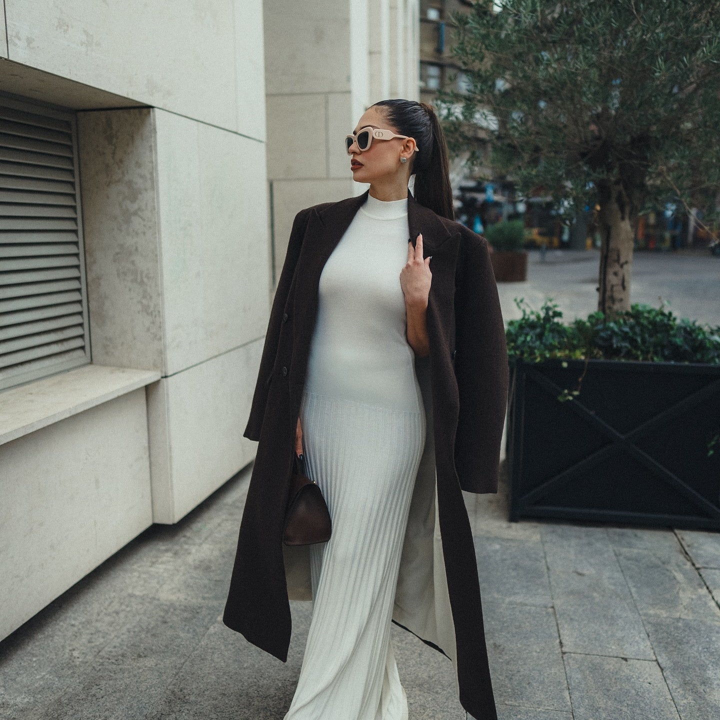 Elegant white ribbed maxi dress with black coat and sunglasses for stylish fashion look