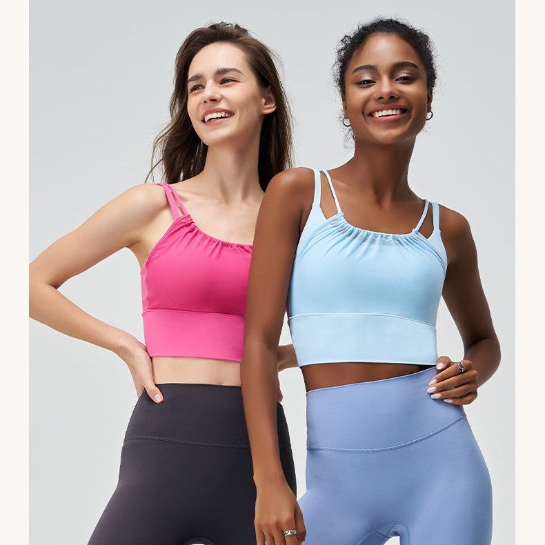 Two women in colorful athletic tops and leggings featuring Glacier Blue and Cherry Blossom Powder