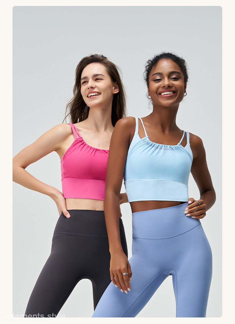 Two women in colorful athletic tops and leggings featuring Glacier Blue and Cherry Blossom Powder