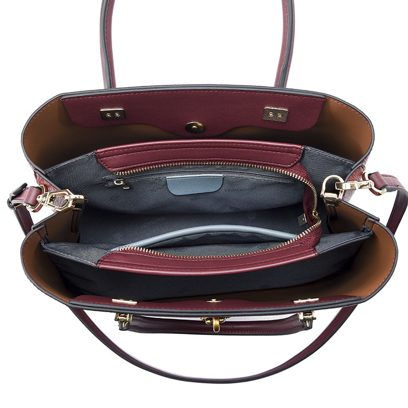 Burgundy leather handbag featuring multiple compartments and metal hardware for stylish fashion