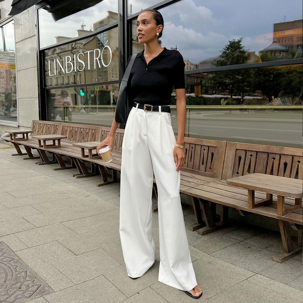 Woman wearing black short-sleeved top and white office wide-leg trousers in Pure White Office collection