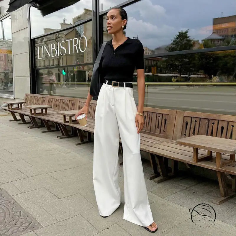 Woman in pure white office trousers with black top and belt