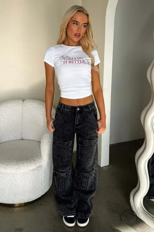 Person in white crop top and vintage pocket washed jeans