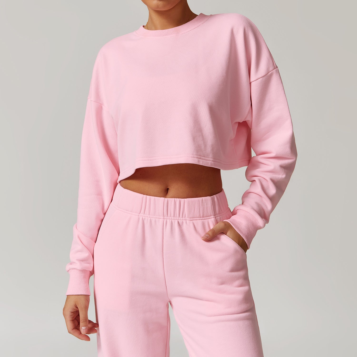 Pink cropped sweatshirt and sweatpants set for fashion-forward long sleeve workouts