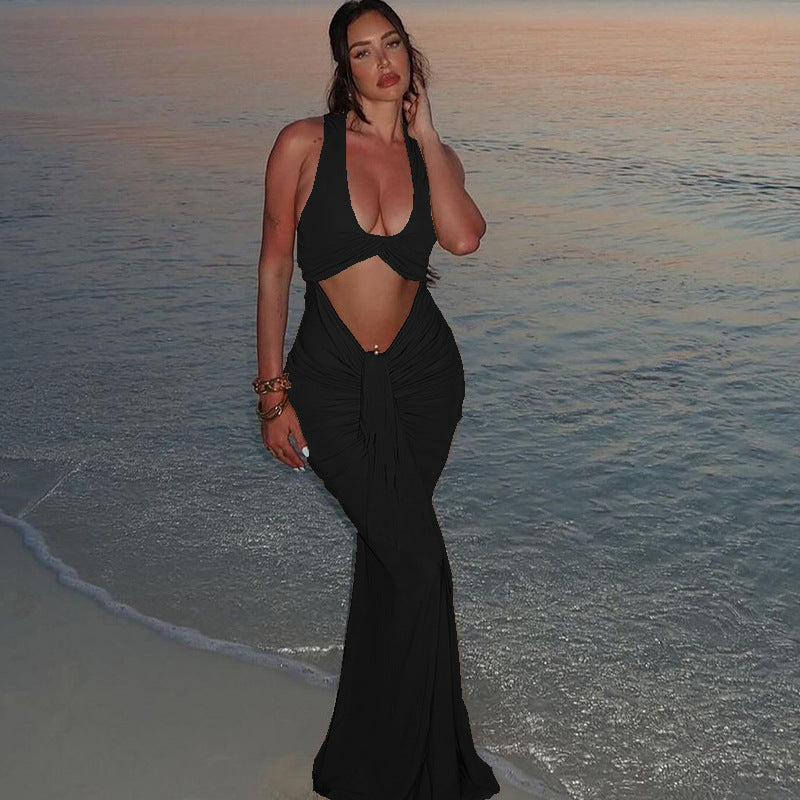Person in black crop top and fitted skirt showcasing Elegant Tight Halter Dress on beach