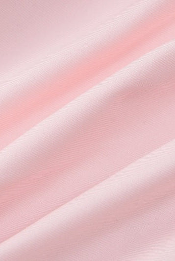 Wrinkled pink fabric of HALTER LOW CUT RUFFLED DRESS showcasing sexy halter low design