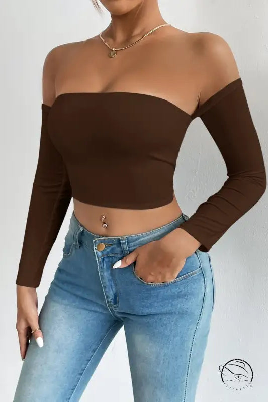 Woman in off-shoulder camisole waist trimming short sleeve crop top