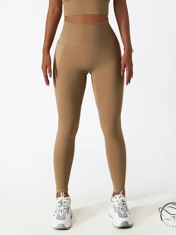 Breathable high-waisted tan yoga pants with white sneakers