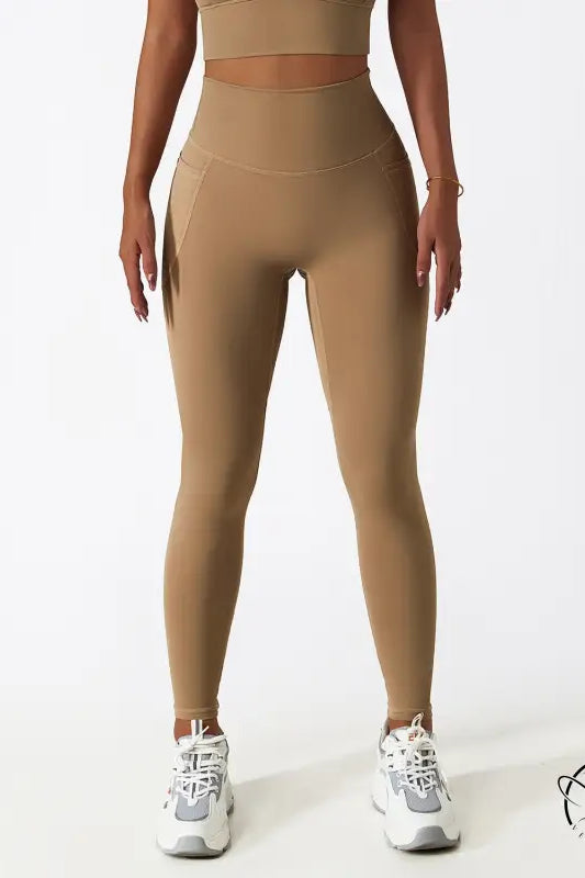 Breathable high-waisted tan yoga pants with white sneakers