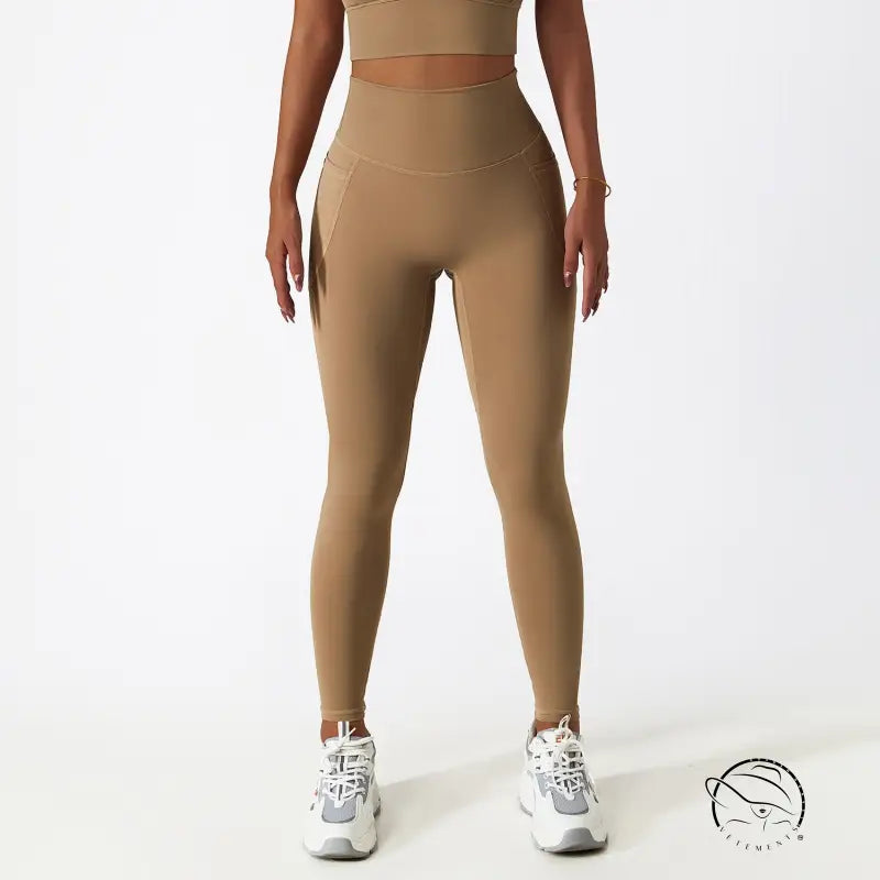 Breathable high-waisted tan yoga pants with white sneakers