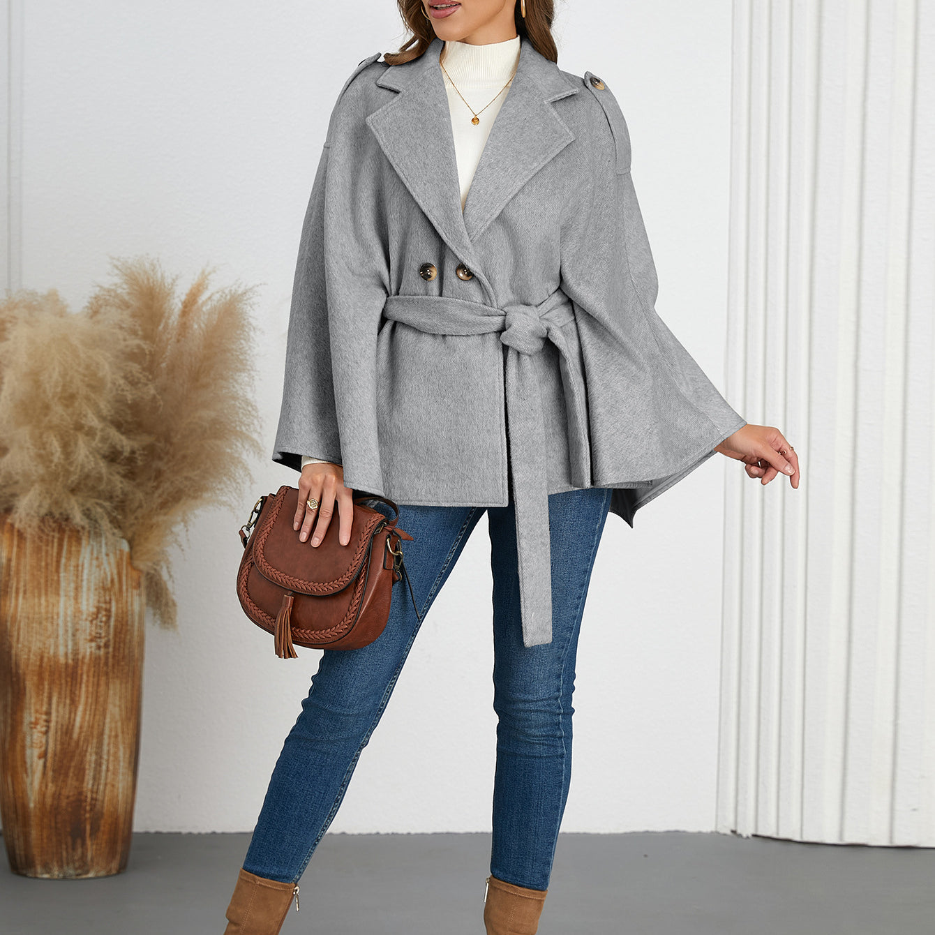 Woman in a gray belted cape coat, highlighting Langry fashion and ملابس for winter