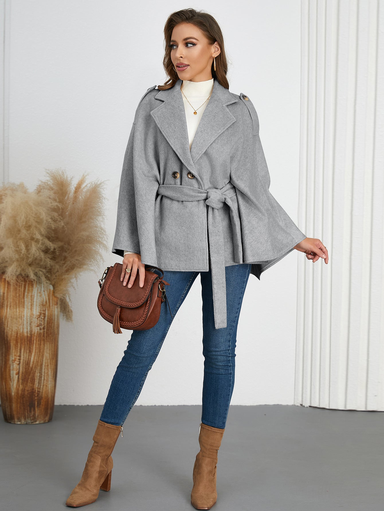 Woman in a gray belted cape coat, highlighting Langry fashion and ملابس for winter