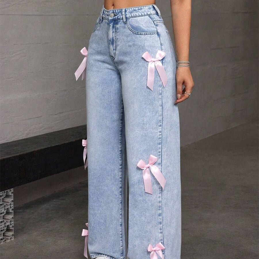 Light wash loose straight leg jeans with pink ribbon bow accents for a stylish look