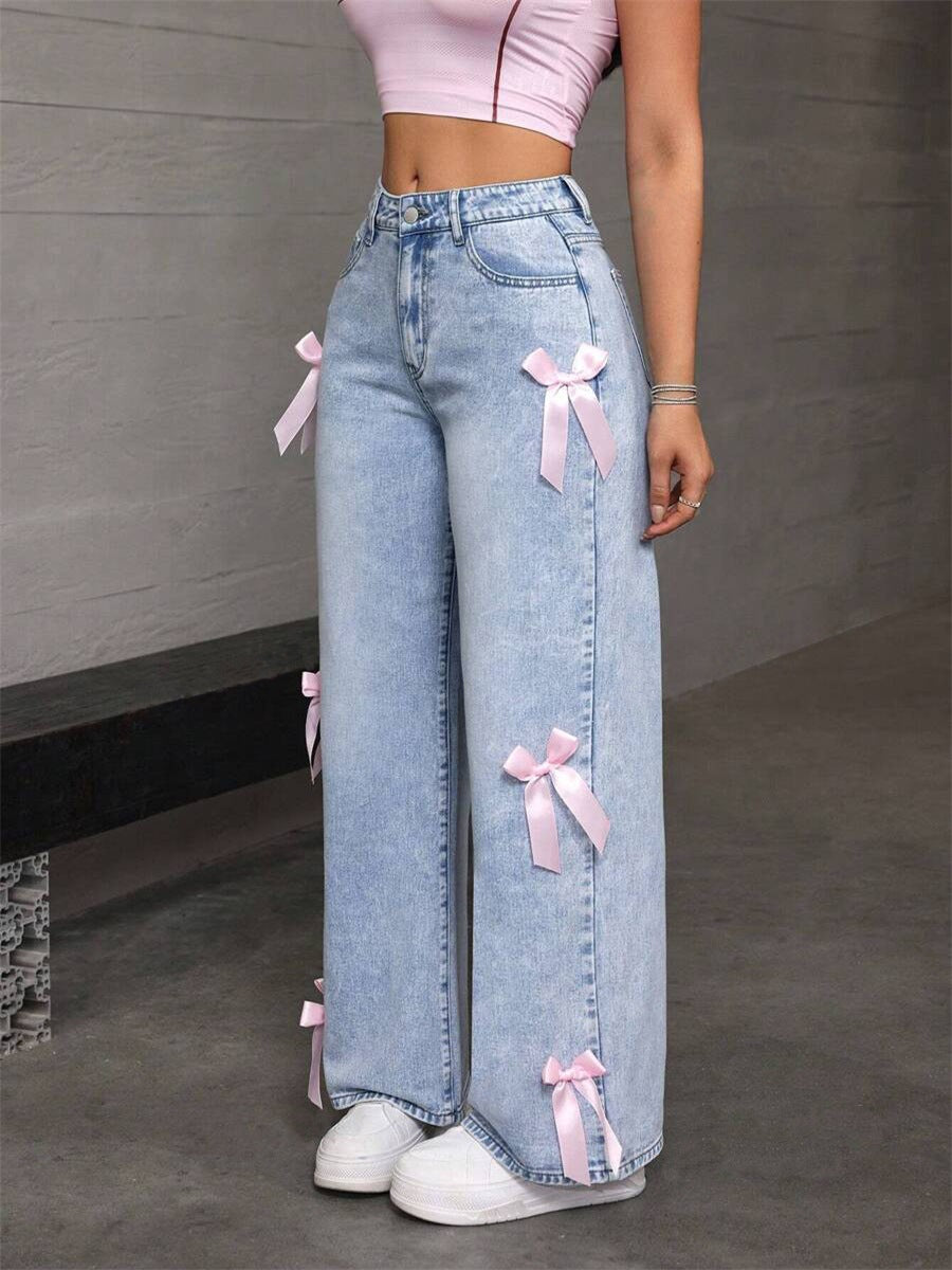 Light wash loose straight leg jeans with pink ribbon bow accents for a stylish look
