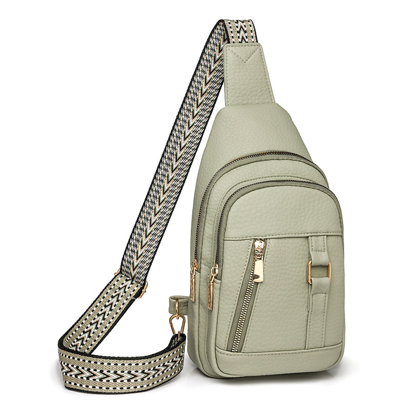 Light green faux leather crossbody bag with patterned strap for trendy fashion styles