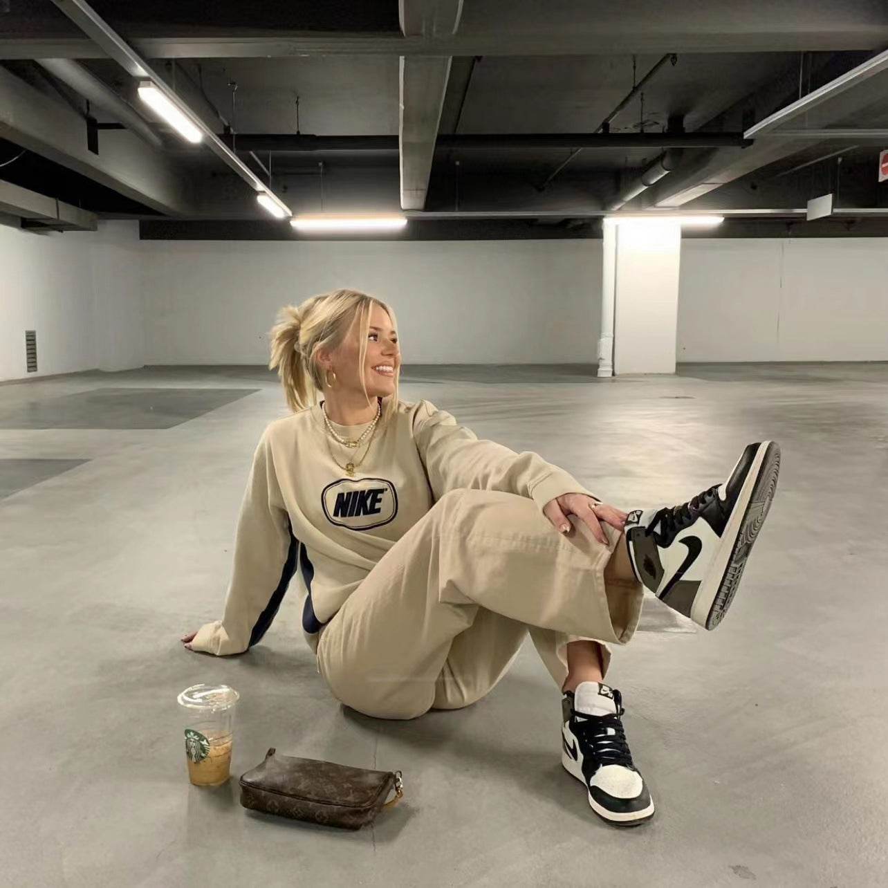 Beige Nike sweatshirt and light khaki high waist trousers in a street smart outfit