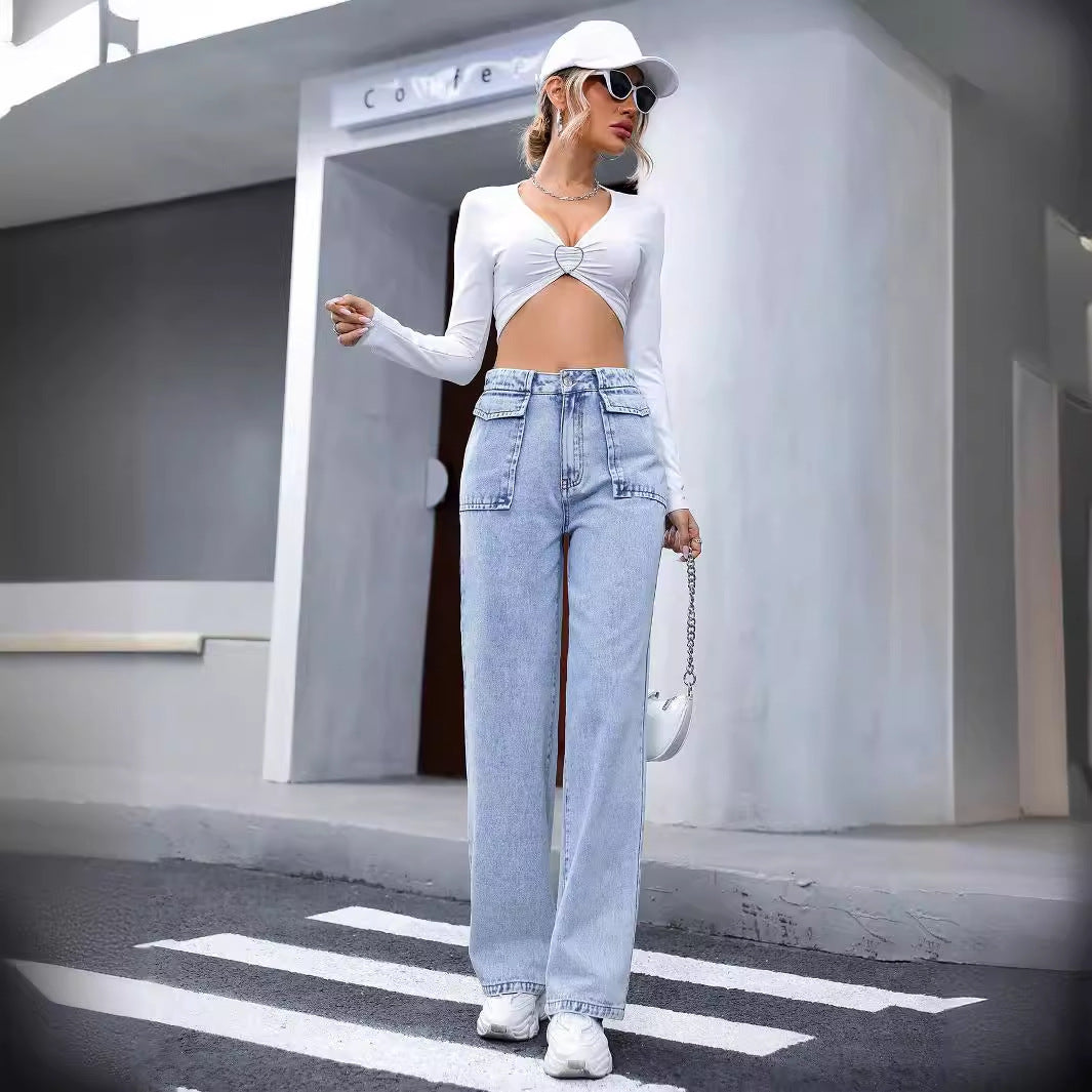 Woman in white crop top and light wash denim trousers showcasing stylish langry fashion