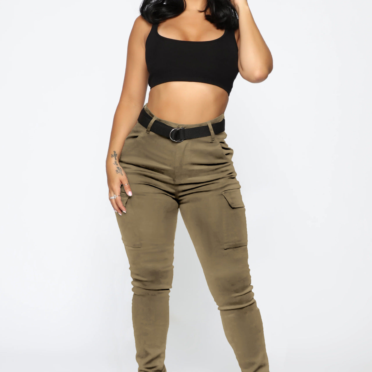 Woman wearing casual skinny stretch belt sports pants with black crop top and olive cargo