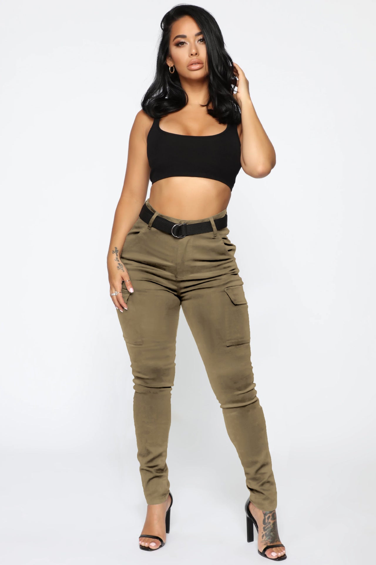Woman wearing casual skinny stretch belt sports pants with black crop top and olive cargo