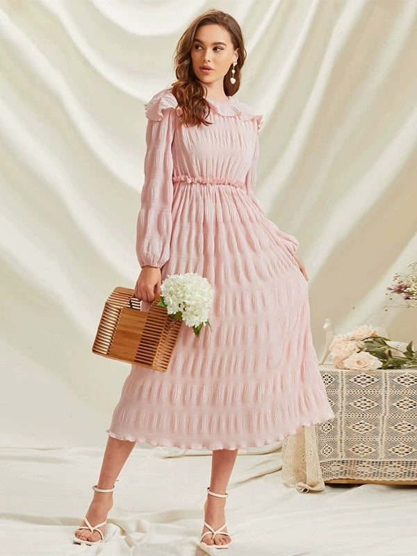 Pastel pink long sleeve ruffled dress with pleated skirt and wooden bag