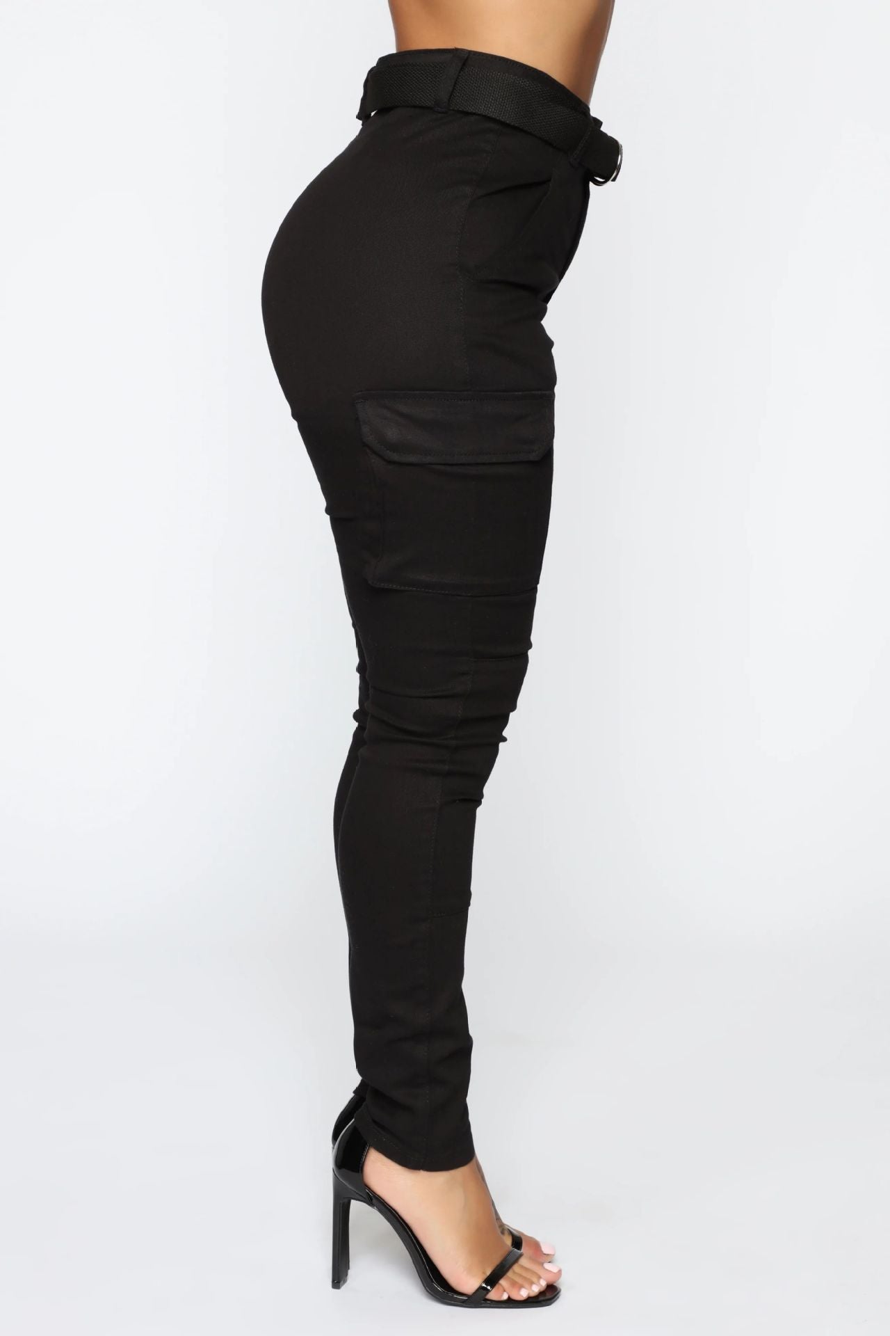 Black belted cargo pants with stiletto heels showcasing casual skinny stretch and stretch belt sports style
