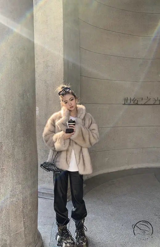 Beige faux fur Langry jacket with black pants and roller skates