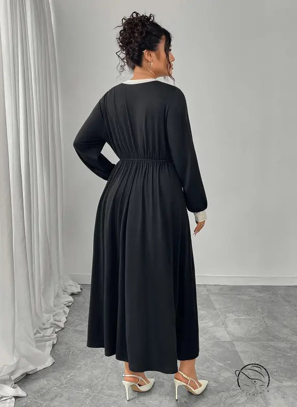 Plus size black dress with white trim and pleated skirt in Langry fashion