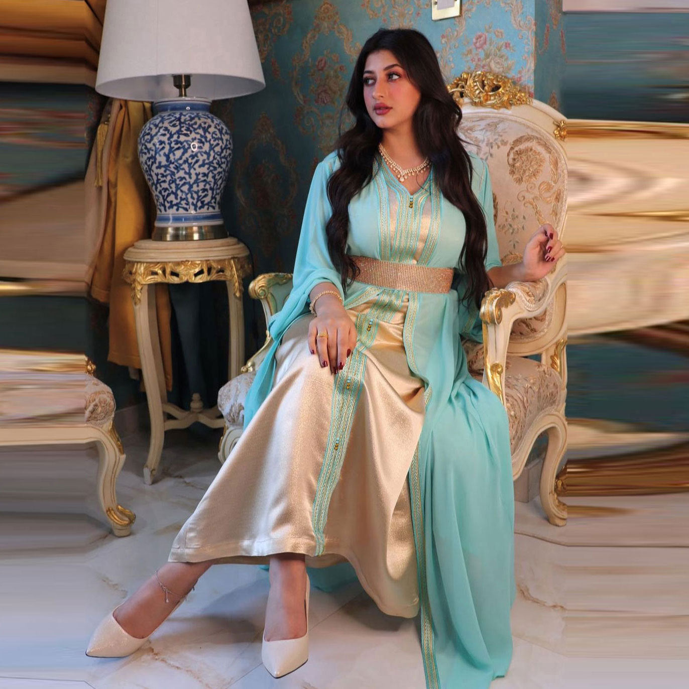 Elegant langry fashion two-piece dress in light blue silk kaftan with gold embroidery, white pants, beige heels