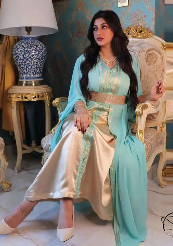 Light blue and gold silk kaftan dress with embroidery, white pants, beige heels