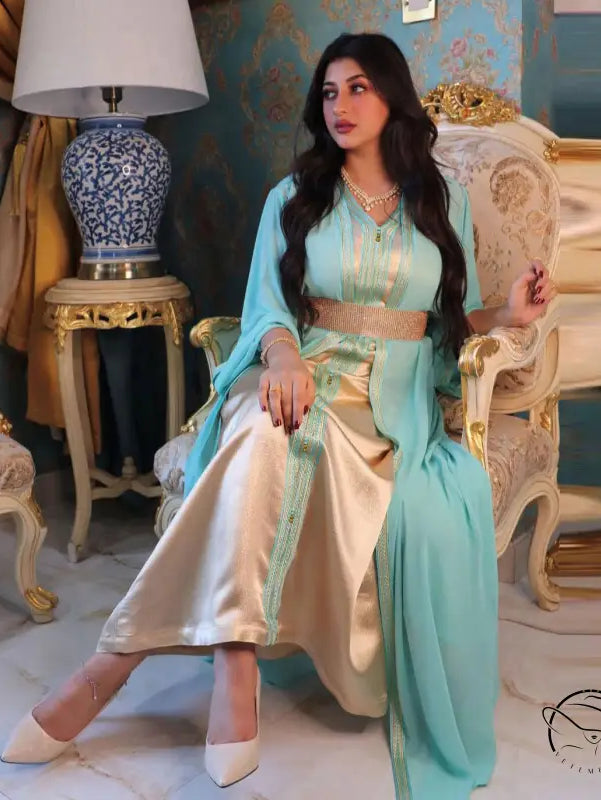 Light blue and gold silk kaftan dress with embroidery, white pants, beige heels
