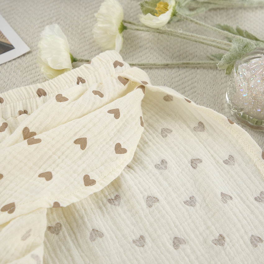 Cream-colored cotton linen slit shorts with light brown heart patterns for summer wear