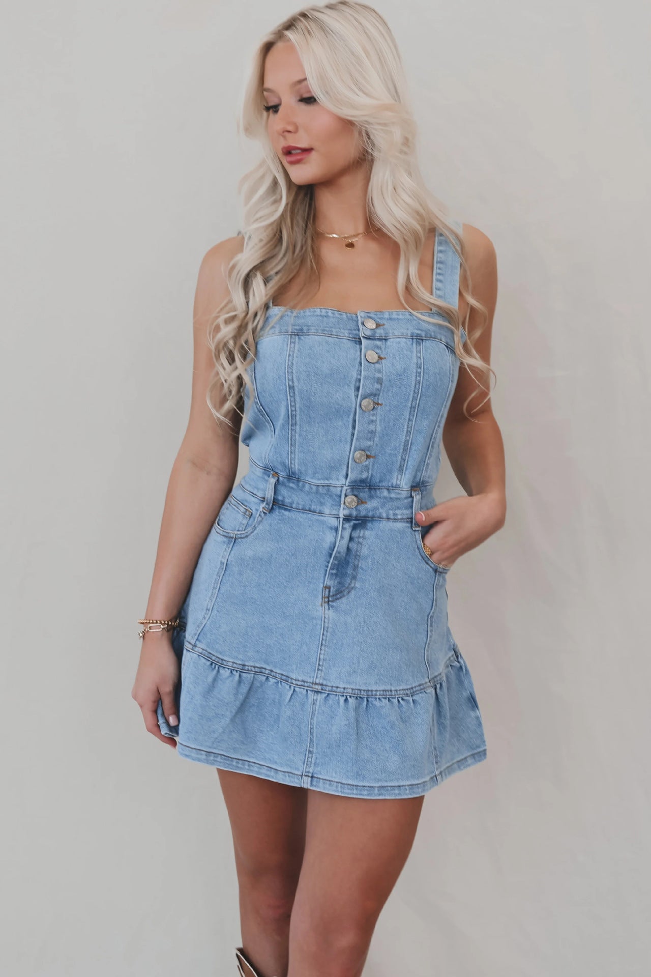Light blue denim mini dress with suspenders and ruffled hem for office suspenders denim style