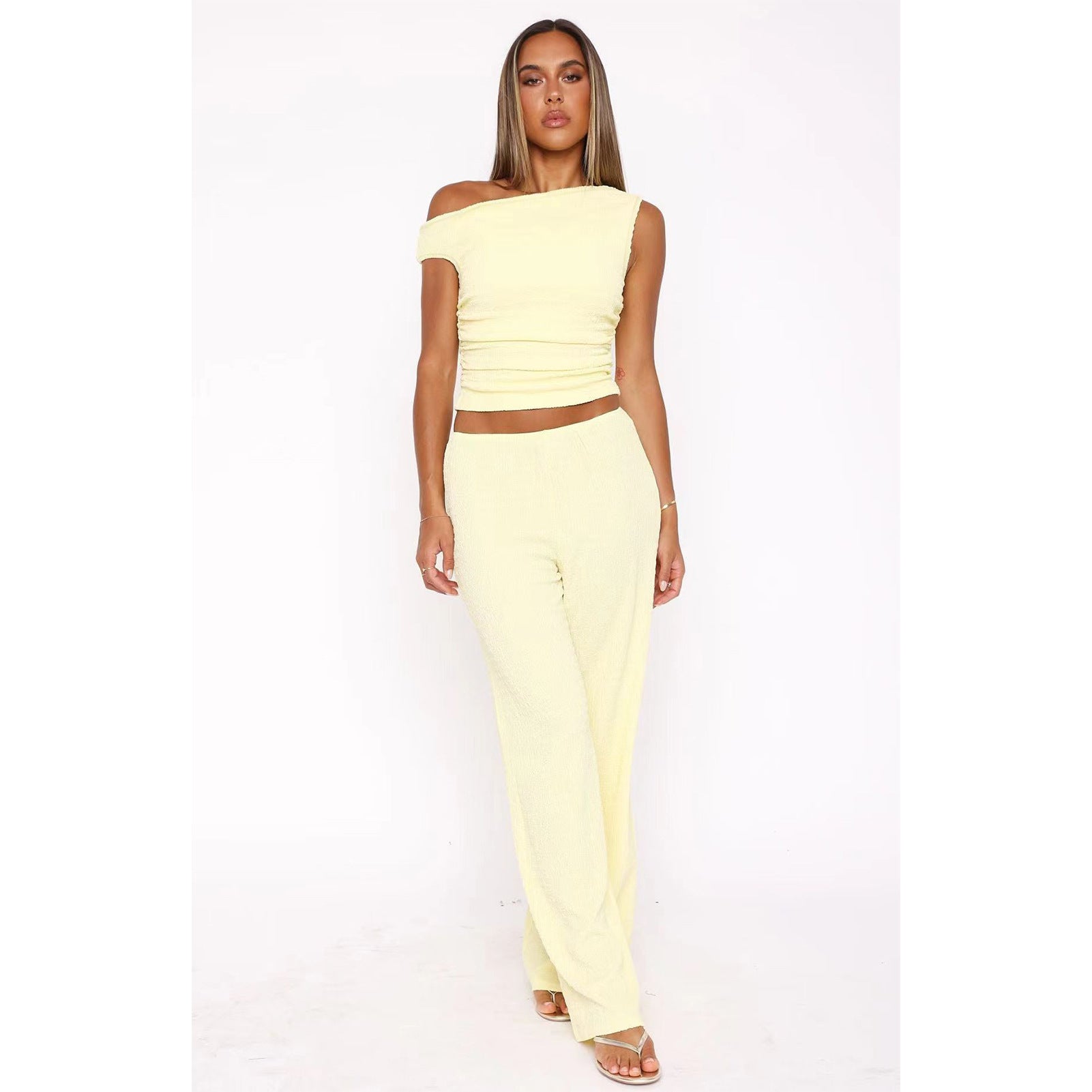 Woman in a yellow two-piece set showcasing stylish ملابس and trendy fashion with wide leg pants