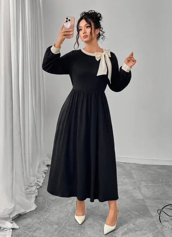 Winter retro slim black dress with white bow and pleated skirt