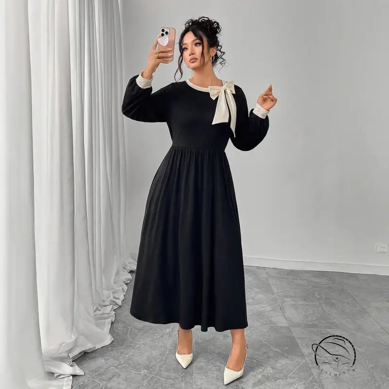 Winter retro slim black dress with white bow and pleated skirt