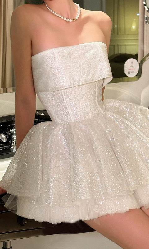 Sparkly white strapless mini dress showcasing elegant off shoulder fashion ملابس