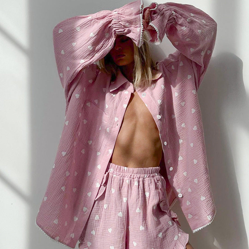 Pink heart-patterned pajamas set with oversized shirt and elastic shorts for stylish comfort