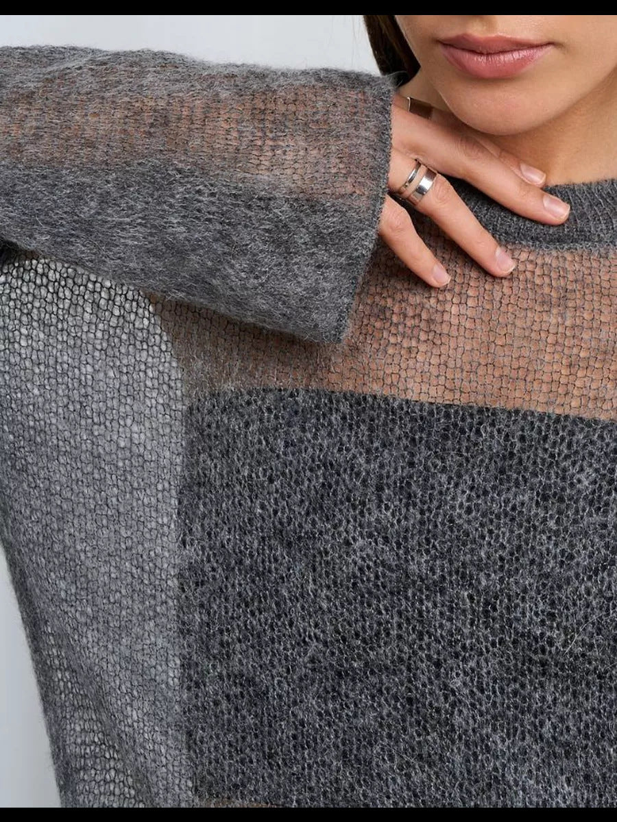 Colorblock knit sweater in grey showcasing a sparkly engagement ring for fashion enthusiasts