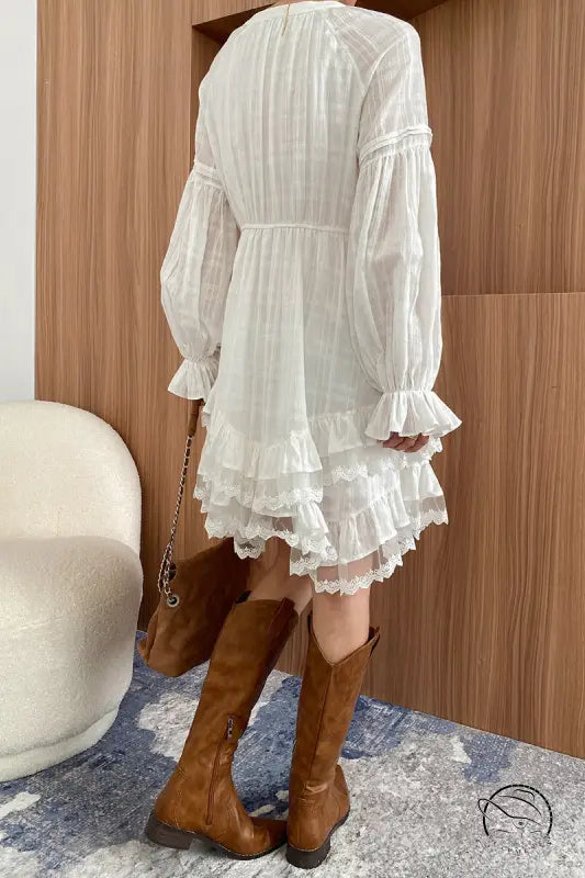 Stunning white layered dress with ruffles and brown boots