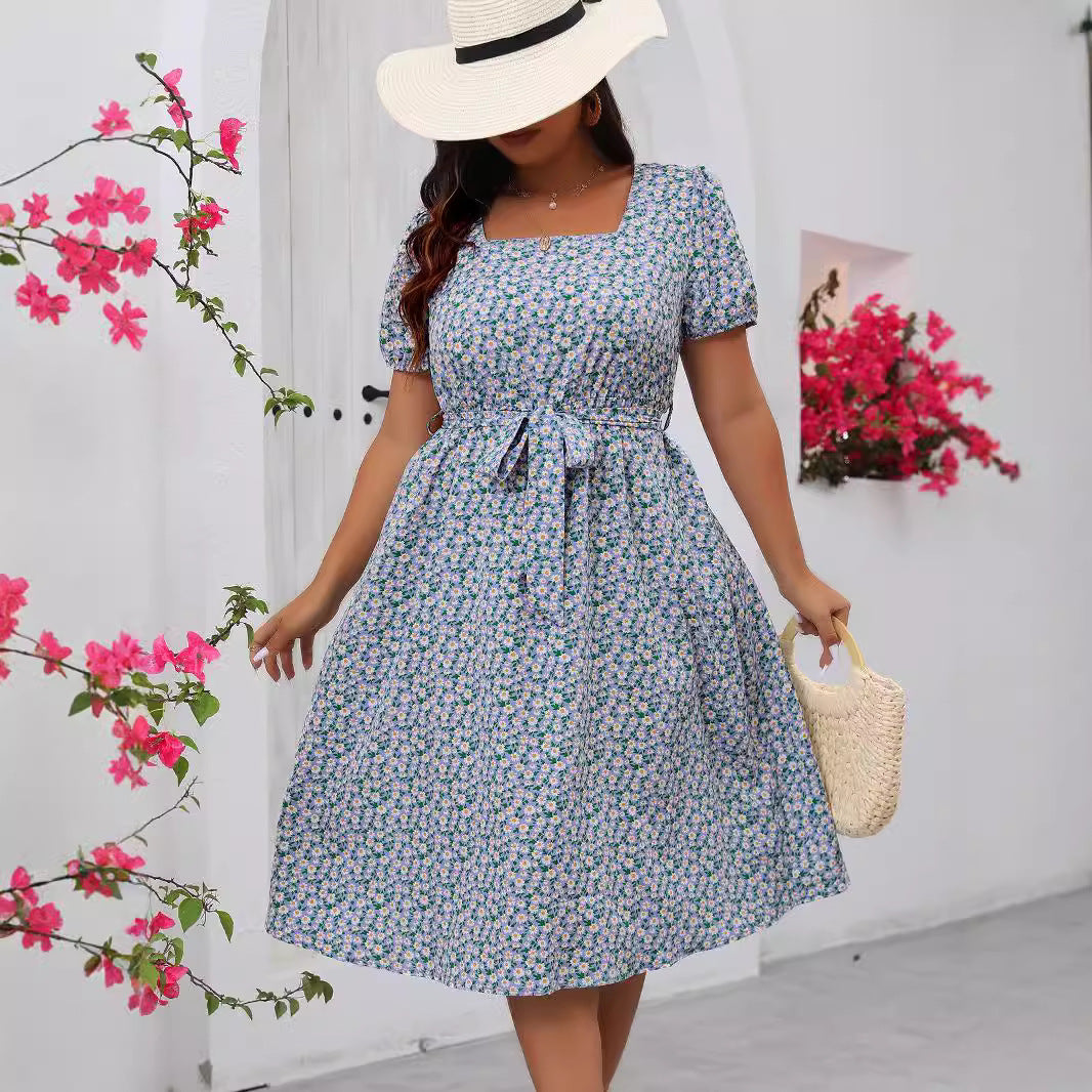 Light blue floral summer dress with square neckline, puff sleeves, and tie waist