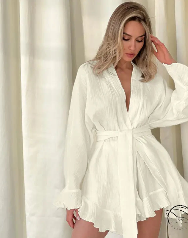 Woman in white pleated wrap dress with long sleeves and loose shorts ruffled pajamas