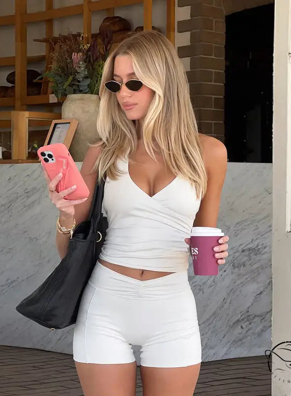 Langry fashion white textured v-neck crop top and high-waisted shorts set for yoga workouts