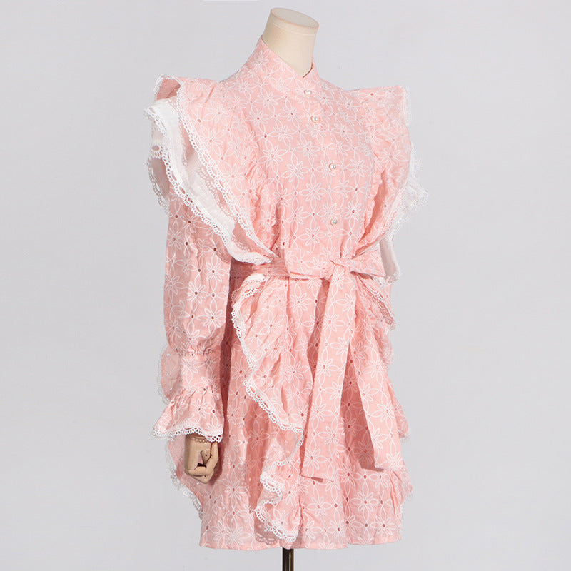 Pink eyelet dress with ruffles featuring a stand collar and stylish bell sleeves