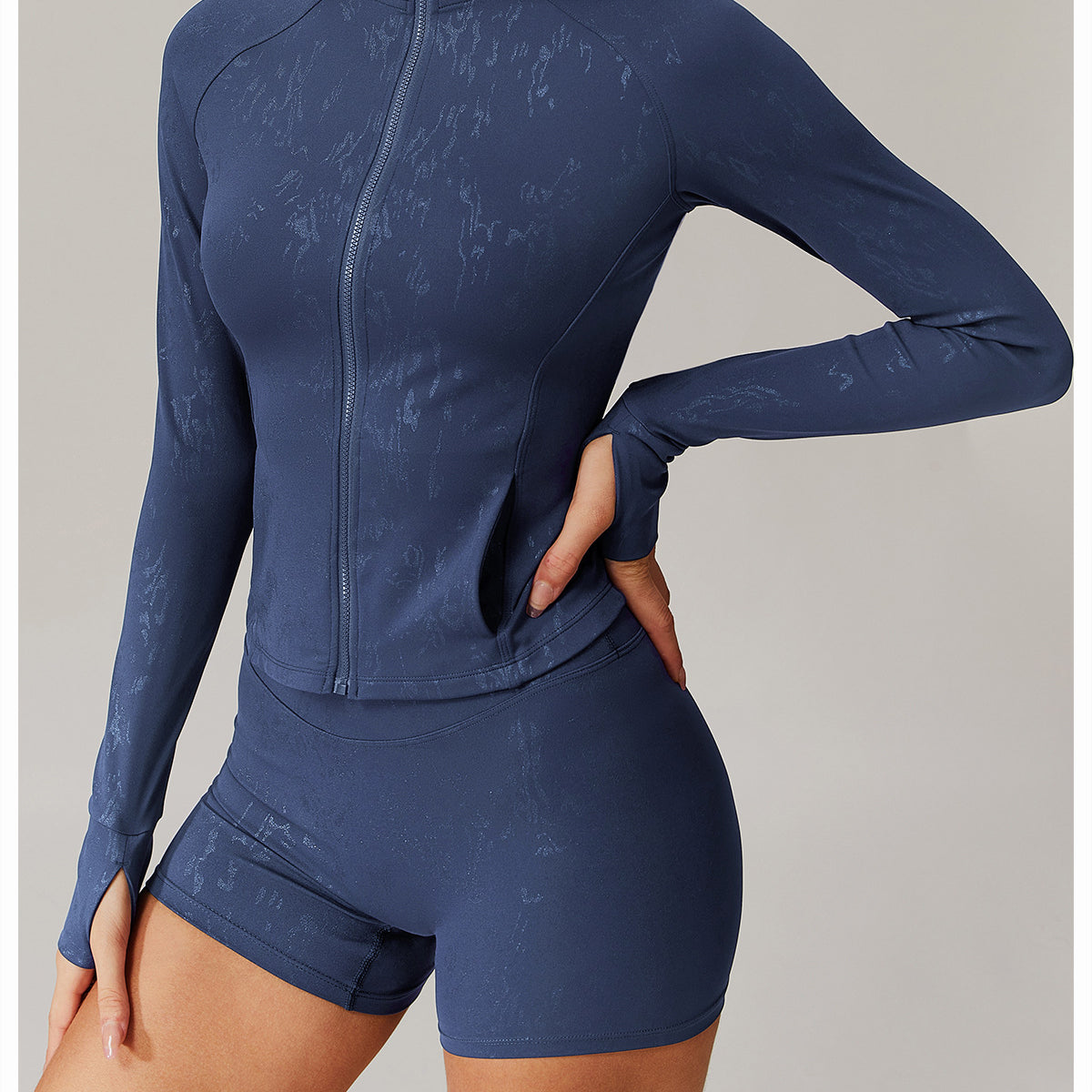 Woman modeling dark blue Quick Drying Breathable Yoga Wear Coat with thumbholes and abstract pattern