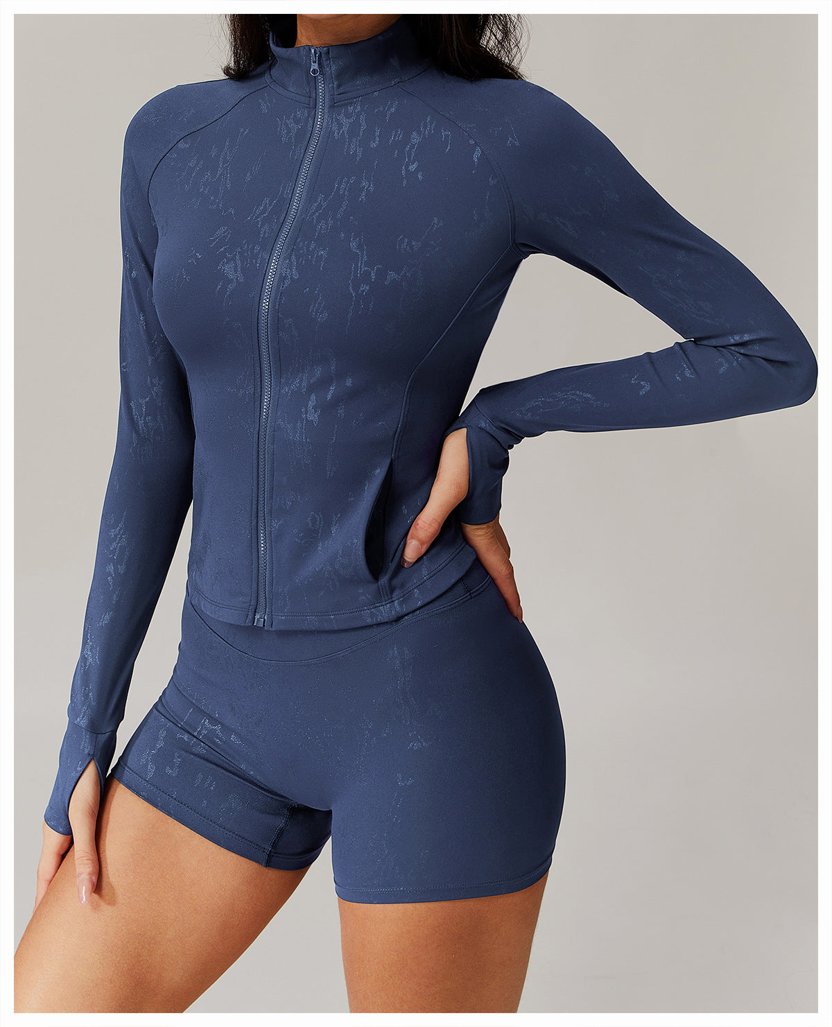 Woman modeling dark blue Quick Drying Breathable Yoga Wear Coat with thumbholes and abstract pattern