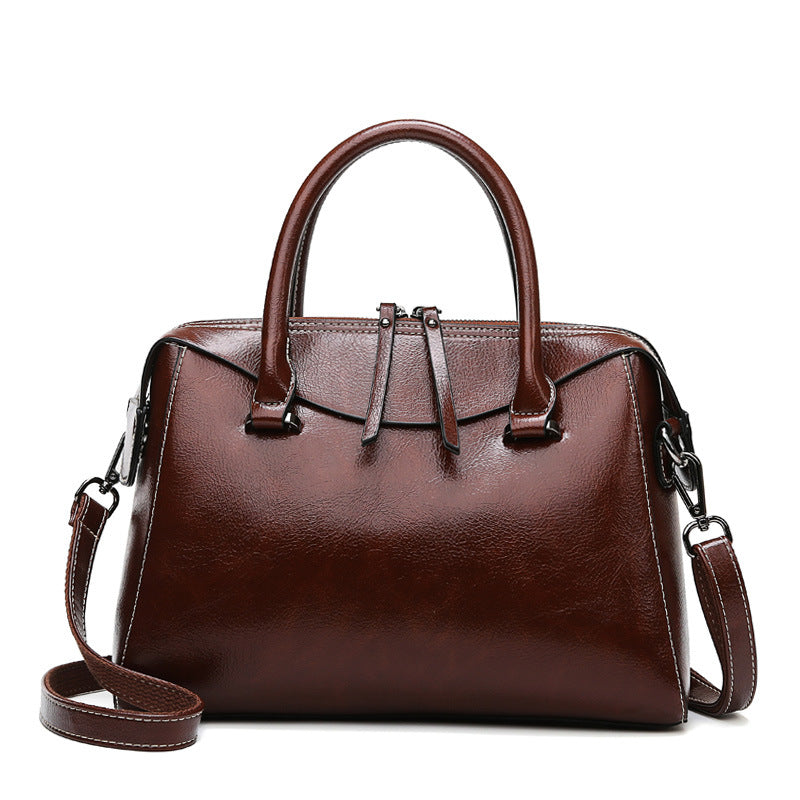 Elegant brown leather langry fashion handbag with structured shape and adjustable strap